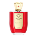 A red bottle of 'Crush On Me' perfume by Uniquee Luxury with a gold cap and label indicating it is an 100 ml extract de parfum.