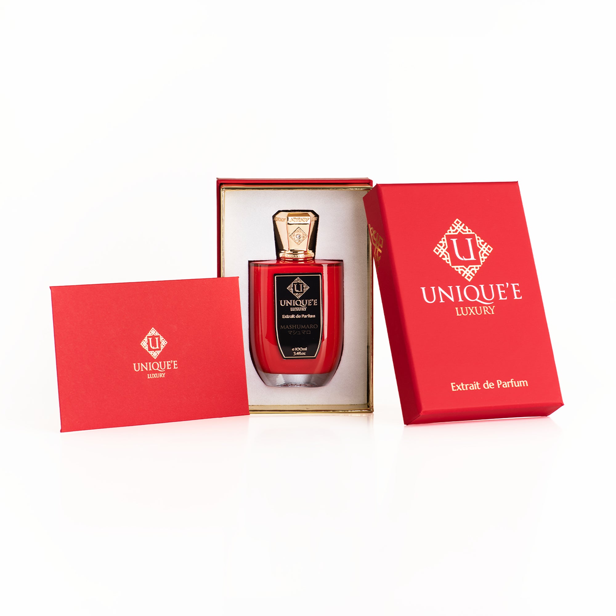A red perfume bottle with a gold cap labeled 'Uniqueé Luxury' and 'Mashumaro'.